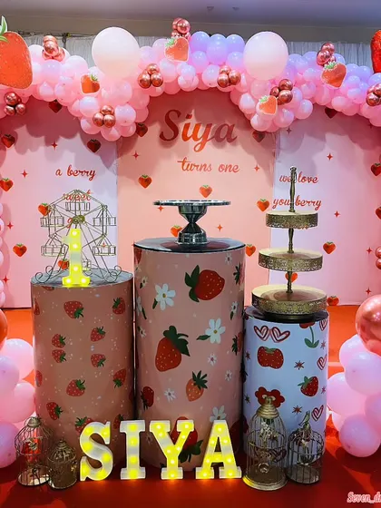 A 'berry' sweet first birthday with a strawberry theme. I used a pink and red balloon arch with strawberry accents, themed cake pedestals, and light-up letters to make this party extra special.