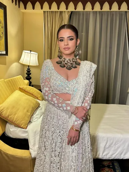 A powerful and regal reception look for Khushboo. The sleek hair and kohl-rimmed eyes create a very strong, high-fashion look that is perfect for a grand celebration.