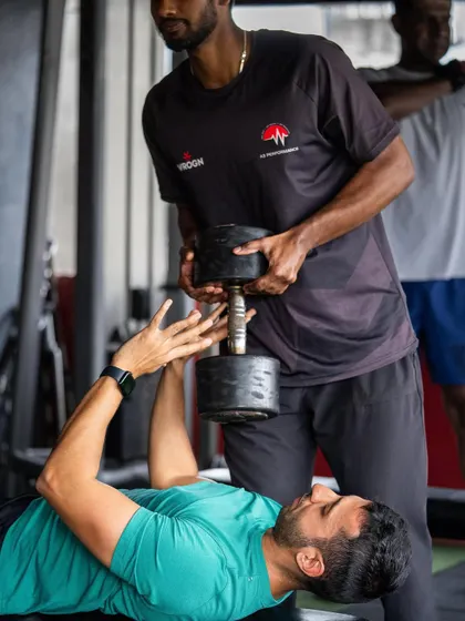 Assisting a client with a neutral grip dumbbell press, an excellent variation for building chest strength while being easier on the shoulders.