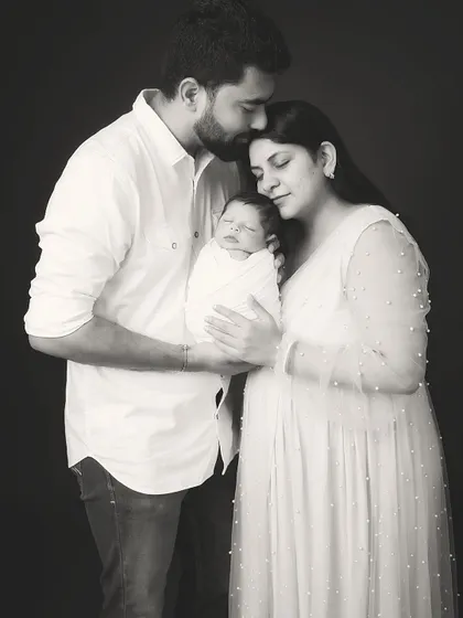 A classic black and white family portrait that becomes an instant heirloom. In this quiet, timeless frame, all that matters is the connection between new parents and their precious baby. This is the kind of powerful, emotive photography I create to tell your family's story for generations.
