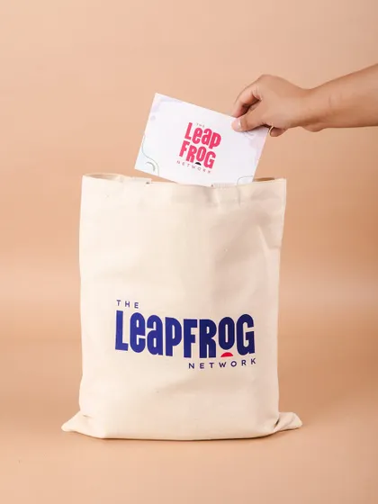 A custom-branded tote bag for The Leapfrog Network's welcome kit. A sturdy and stylish tote is a practical and appreciated gift for any new team member.