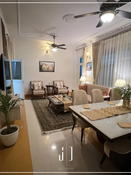 The living and dining area of a suite in the guest house. We combined classic furniture with modern touches to create a warm, inviting space for state guests to unwind.