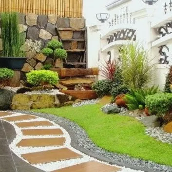 This design features a winding pathway with stone pavers, a multi-level rock garden with a small water feature, and a variety of plants to create a tropical, resort-style feel.
