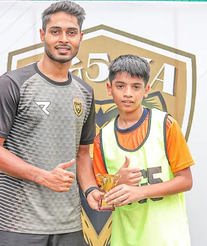 A player receiving his Player of the Match award from his coach, recognizing his standout performance in the tournament.
