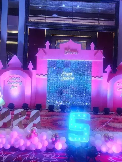 A grand Peppa Pig castle theme for a 5th birthday. The entire stage was transformed into a pink castle, complete with a shimmering sequin entrance and light-up Peppa Pig characters.
