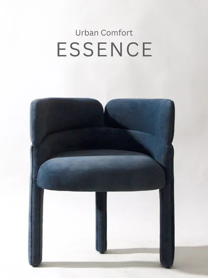 This modern armchair in a deep blue velvet is the essence of urban comfort. Its unique, split-back design and fully upholstered legs make it a contemporary statement piece.