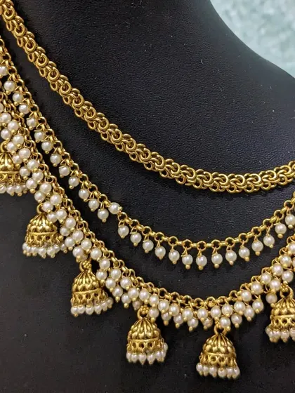 Another view of the multi-layered jhumka ear chains.