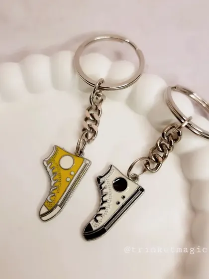 Step up your keychain game with these cool sneaker charms. Available in yellow and black, they are a stylish accessory for any sneakerhead.