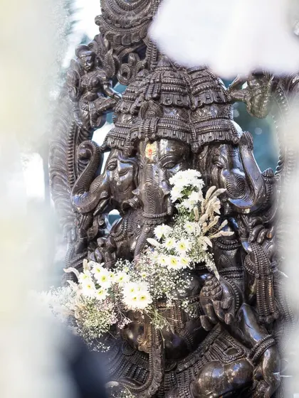 A close-up of the divine Ganesha idol, adorned with delicate white flowers. Integrating spiritual elements with reverence and artistry is a key part of my design process for traditional ceremonies.