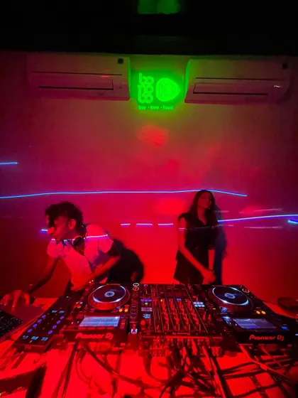 A wide shot of the DJ console at Bonobo during a 'Homie' night. The red lighting and intimate setting create a special vibe.