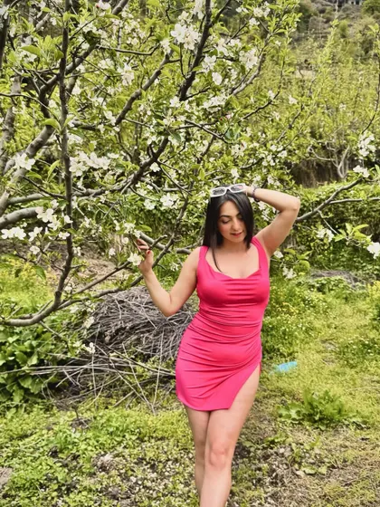Romanticizing life in a pink dress amidst blooming apple trees. This photo is all about finding beauty in the simple moments.
