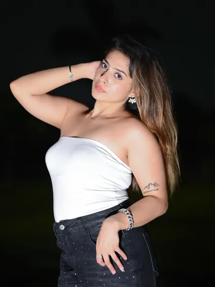 A classic portrait pose, using flash photography to create a sharp, high-fashion look.