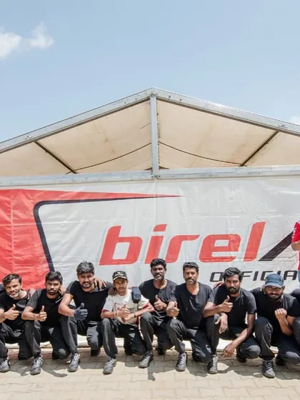 The entire team celebrating a successful race weekend. Every member plays a vital role in getting our drivers onto the podium.