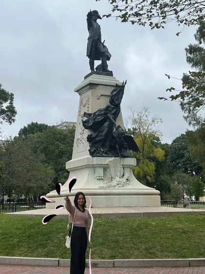 Posing with a statue, with a little doodle magic coming from my hand.
