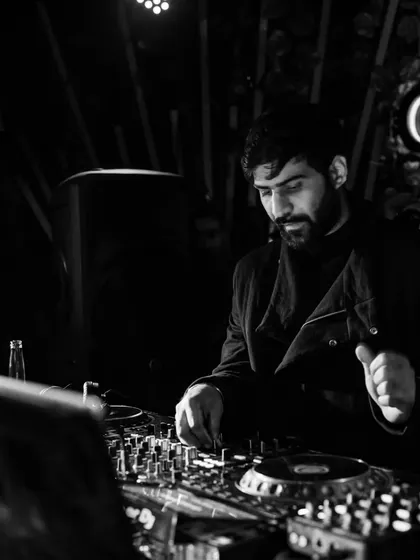 A candid moment at the decks, fully absorbed in the mix. Every set is a journey, and I'm the guide.