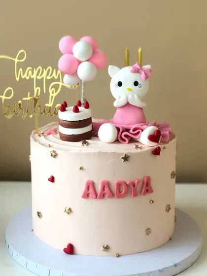 A cute Hello Kitty cake for a special birthday, complete with a mini cake and a balloon bouquet.