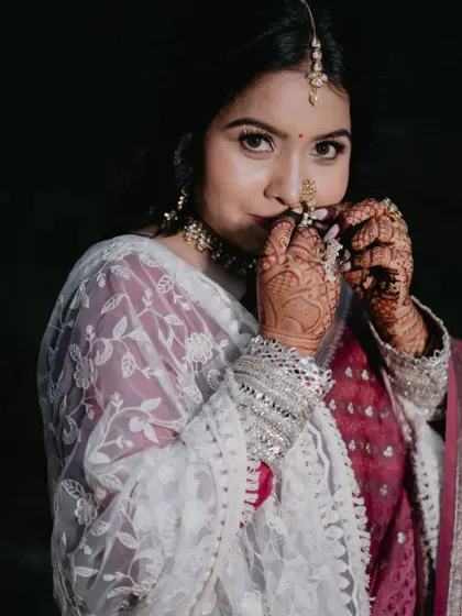 A close-up shot focusing on the bride's expressive eyes and the traditional nath, a centerpiece of Maharashtrian bridal jewelry.