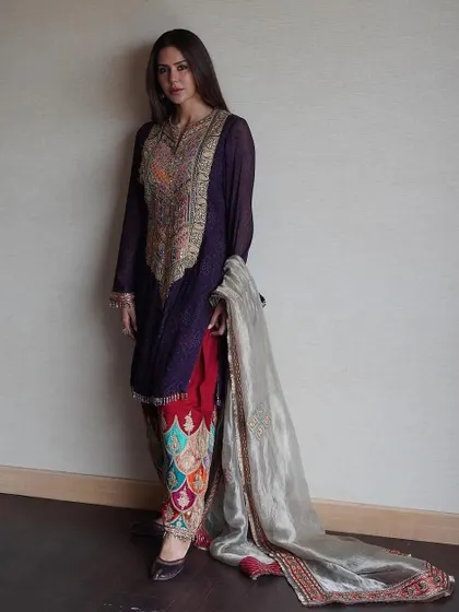 The full look of this stunning Rimple and Harpreet creation. The combination of the deep purple kurta with brightly embroidered pants is a masterclass in color play.