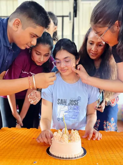 Friends gather around to share in the birthday fun. These moments of connection are what build our strong studio family.