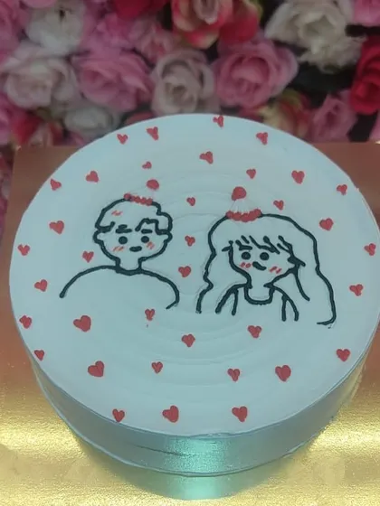 A cute, minimalist cake with a hand-drawn couple. These semi-customized drawing cakes are a trendy and affordable way to personalize your celebration.