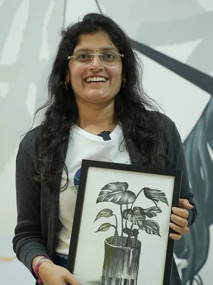 A participant with her framed charcoal drawing. My workshops help you build the skills to create realistic and expressive art.