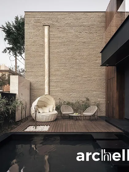 A private poolside nook at one of our modern residences, featured in Archello. We design these spaces to be personal retreats, where a comfortable daybed and the gentle sound of water create a perfect escape.