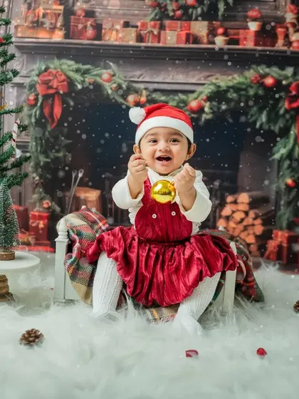 A big, joyful laugh while holding a shiny gold ornament. This is the kind of infectious happiness I love to capture.