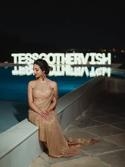A quiet moment for the bride. Even in repose, her bold red lip and shimmering makeup exude pure elegance and glamour.