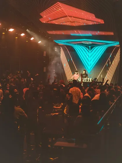 A wide view of the stage and the massive crowd at Glitte Superclub. The visuals and lighting are a huge part of the show.