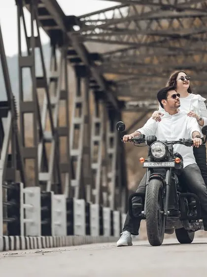 This shot captures the feeling of hitting the open road together. The low angle and the couple looking ahead create a sense of shared adventure and looking towards the future.