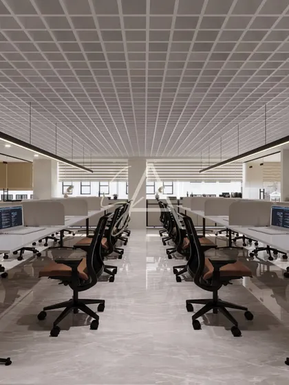 This is a view of the open-plan workstation area in our Defence Colony project. We focused on a clean, organized layout with a neutral color palette and linear pendant lighting to create a bright and productive environment for the team.