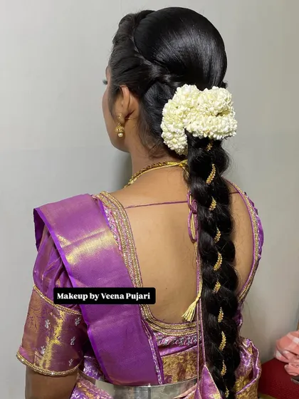 A beautiful and neat traditional braid, accented with gold thread and a gajra. This hairstyle is perfect for any festive occasion.