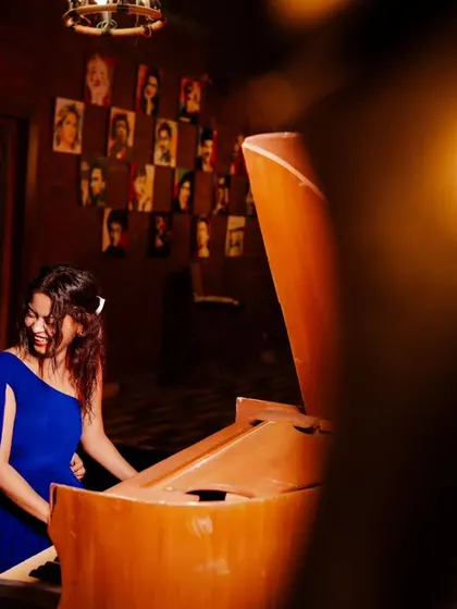 A candid moment of shared laughter at the piano. I used creative framing to capture this intimate scene, making it feel like a private moment the viewer is peeking into.