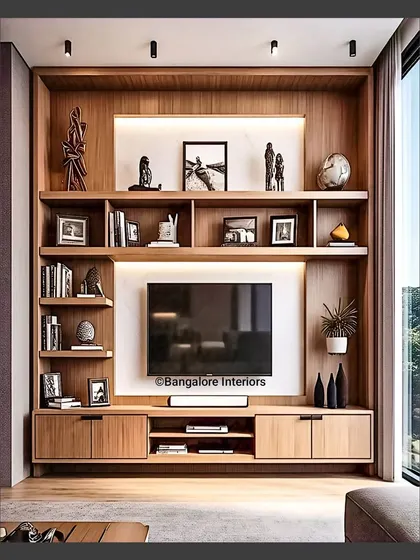 This floor-to-ceiling media unit is built around the TV, offering a library-like feel with extensive shelving for books and decor. The warm wood finish and integrated backlighting create a cozy and inviting atmosphere.