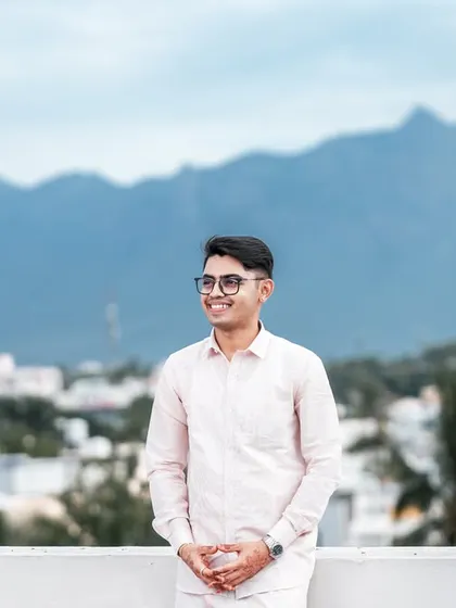 A relaxed solo portrait of the groom enjoying the view from the Coimbatore rooftop.