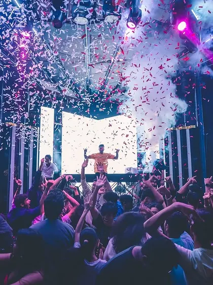 A wide shot of the crowd at FLO Church Street, with hands in the air as confetti and CO2 fill the room. This is the unforgettable universe we create together.