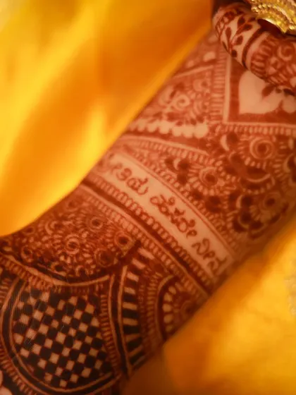 A close-up of the Kannada script on the arm, showing the beautiful stain color.