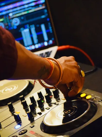 A close-up of my hand on the mixer. This is where the magic happens, blending beats and creating the energy for the dance floor.
