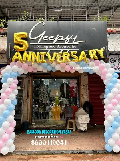For the 5th anniversary of a clothing store, I set up this welcoming balloon arch right at the entrance. The design uses soft pink, blue, and white balloons with large gold foil letters to attract customers and celebrate the occasion.