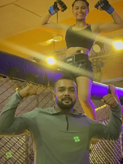 Celebrating a victory. A female fighter and I flexing after a successful competition.