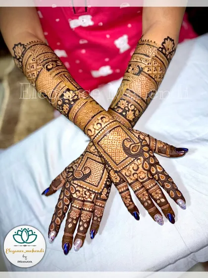 A heavy backhand design for a guest or family member, with dense patterns that match the bridal style.