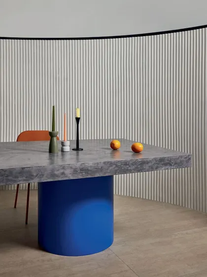A 3D wallcovering that turns a wall into a soft, sculptural work of art. The gentle, repeating vertical lines add architectural interest and a velvety texture to this modern dining space.