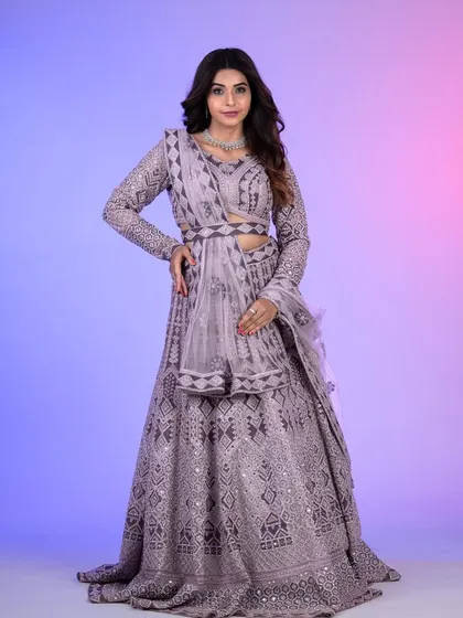 A full view of this stunning lilac lehenga, featuring a belted dupatta for a modern touch. The intricate geometric embroidery and mirror work are absolutely breathtaking.