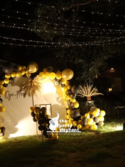 A wide shot of the illuminated photo backdrop at night, set against the canopy of fairy lights, showcasing the magical ambiance I created for this 40th birthday.