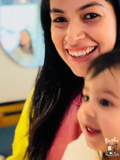 The youngest artist in our Mother's Day workshop, watching with wide-eyed wonder. Our space is welcoming for all ages.