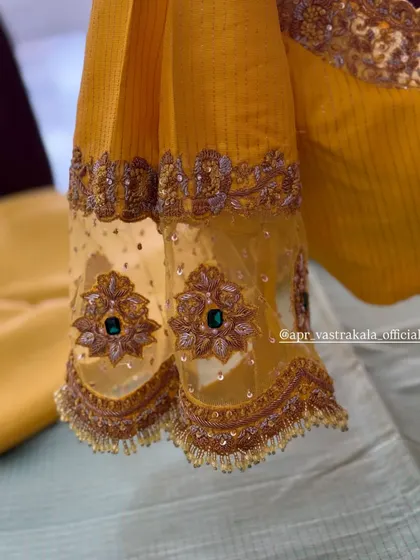 A close-up of the sheer sleeves with zardosi and stone work.