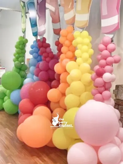 I love creating unique decor elements. This installation features colorful balloons pouring out of giant paint tubes, perfectly capturing the fun and messy spirit of an art party.