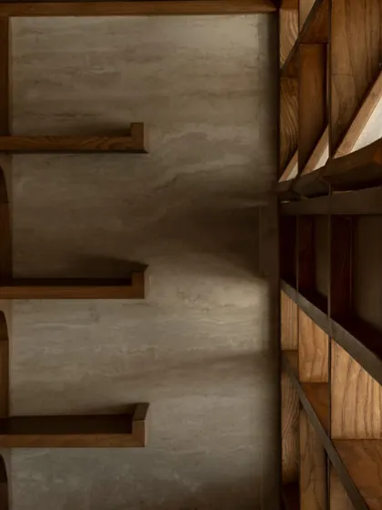 Details of the custom joinery and shelving at QBF Coffee. The design language is one of honest craftsmanship, with exposed brackets and a mix of wood and stone textures.
