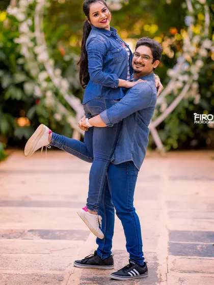 A joyful and energetic lift! This fun portrait in matching denim outfits perfectly captures the couple's playful and happy relationship.