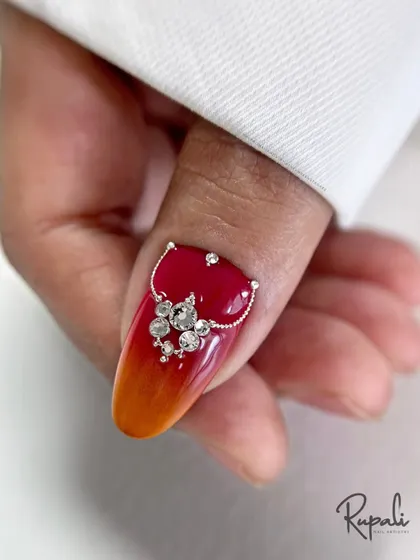 Another angle of the fiery ombre design, showing how the crystal placement follows the curve of the nail for a seamless, integrated look.